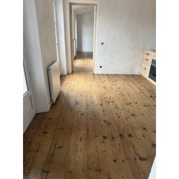 Plancher ancien en pin à lames larges.